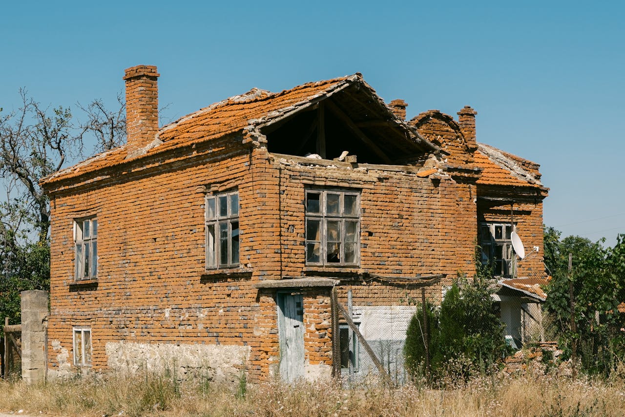 A close-up shot of an abandoned brick house in Varna, Bulgaria, showcasing architectural decay.